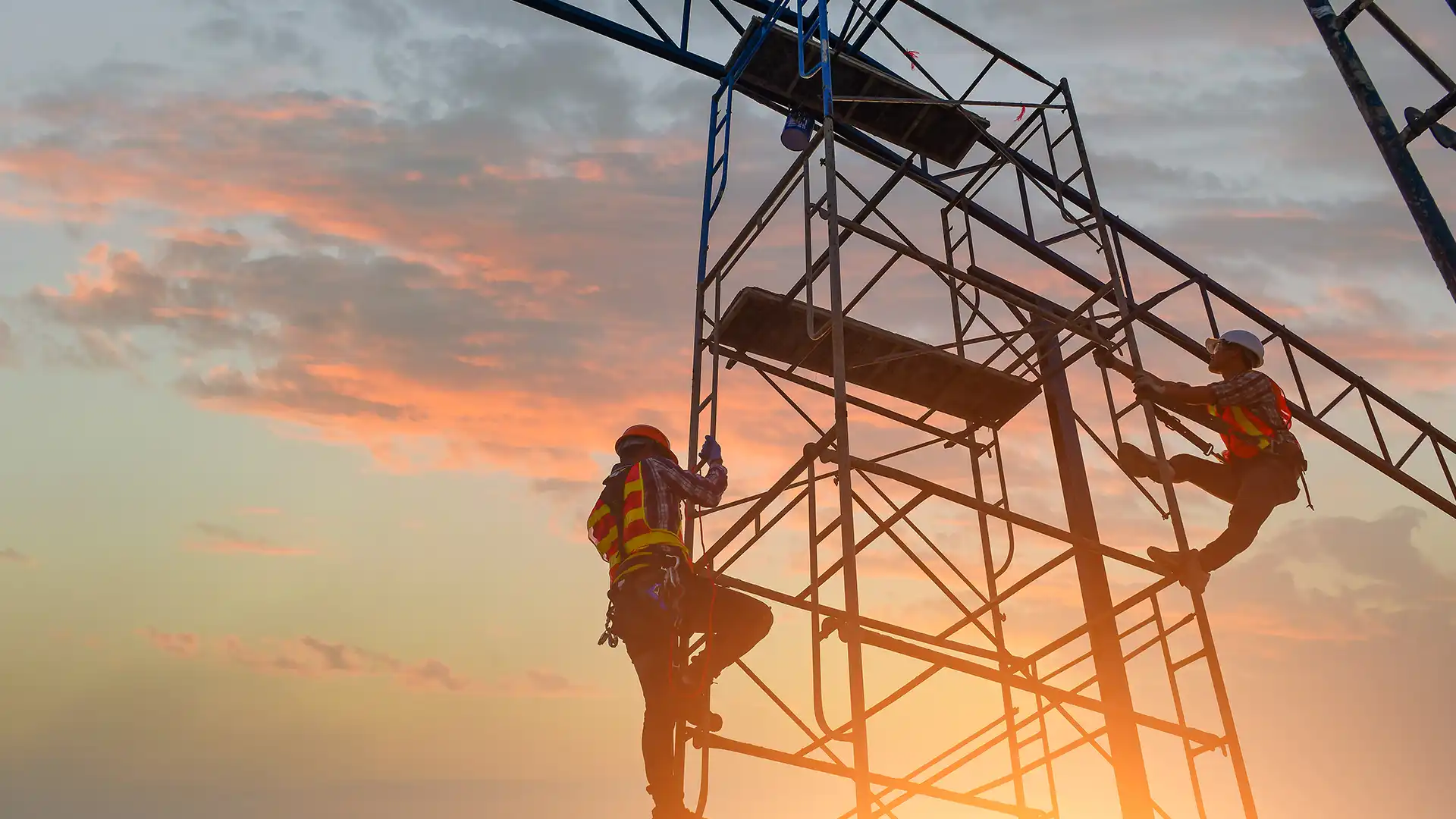 Workers climbing the scaffold are secured with a Retractable Fall Arrest system.